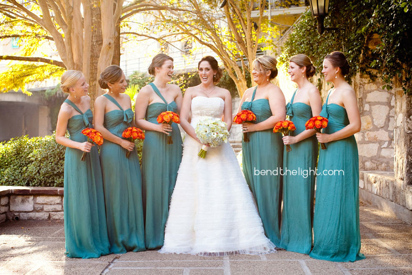 Turquoise bridesmaid dresses and red orange yellowish flowers